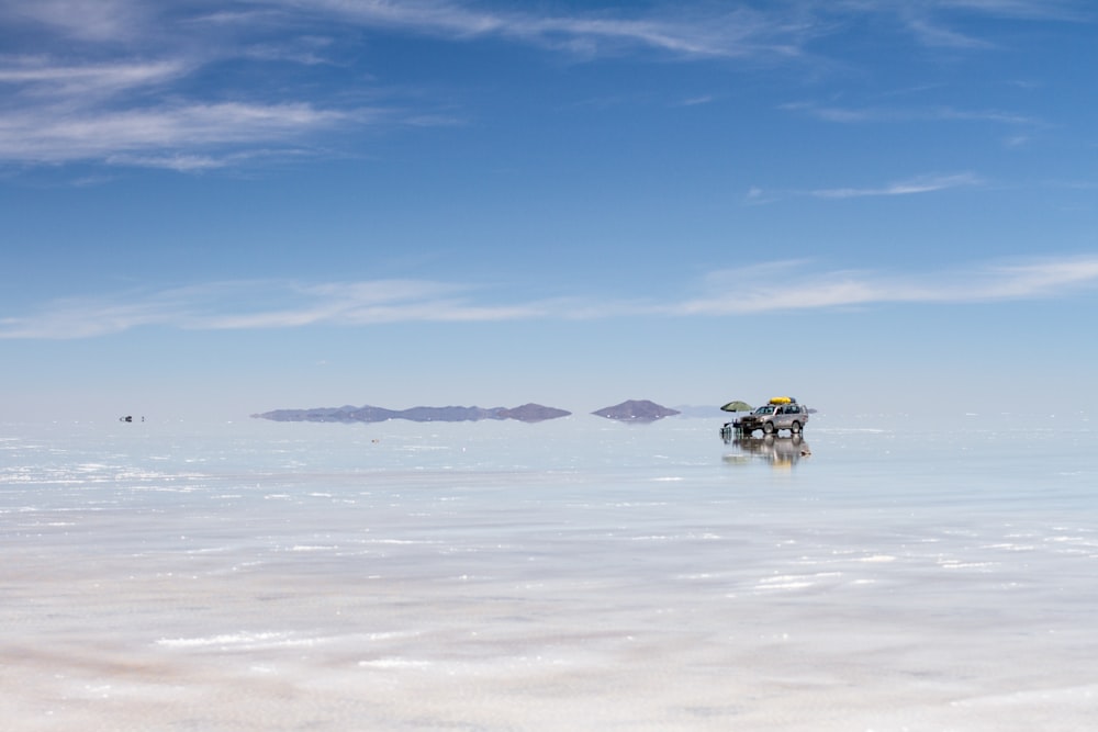 a vehicle driving through a snowy landscape