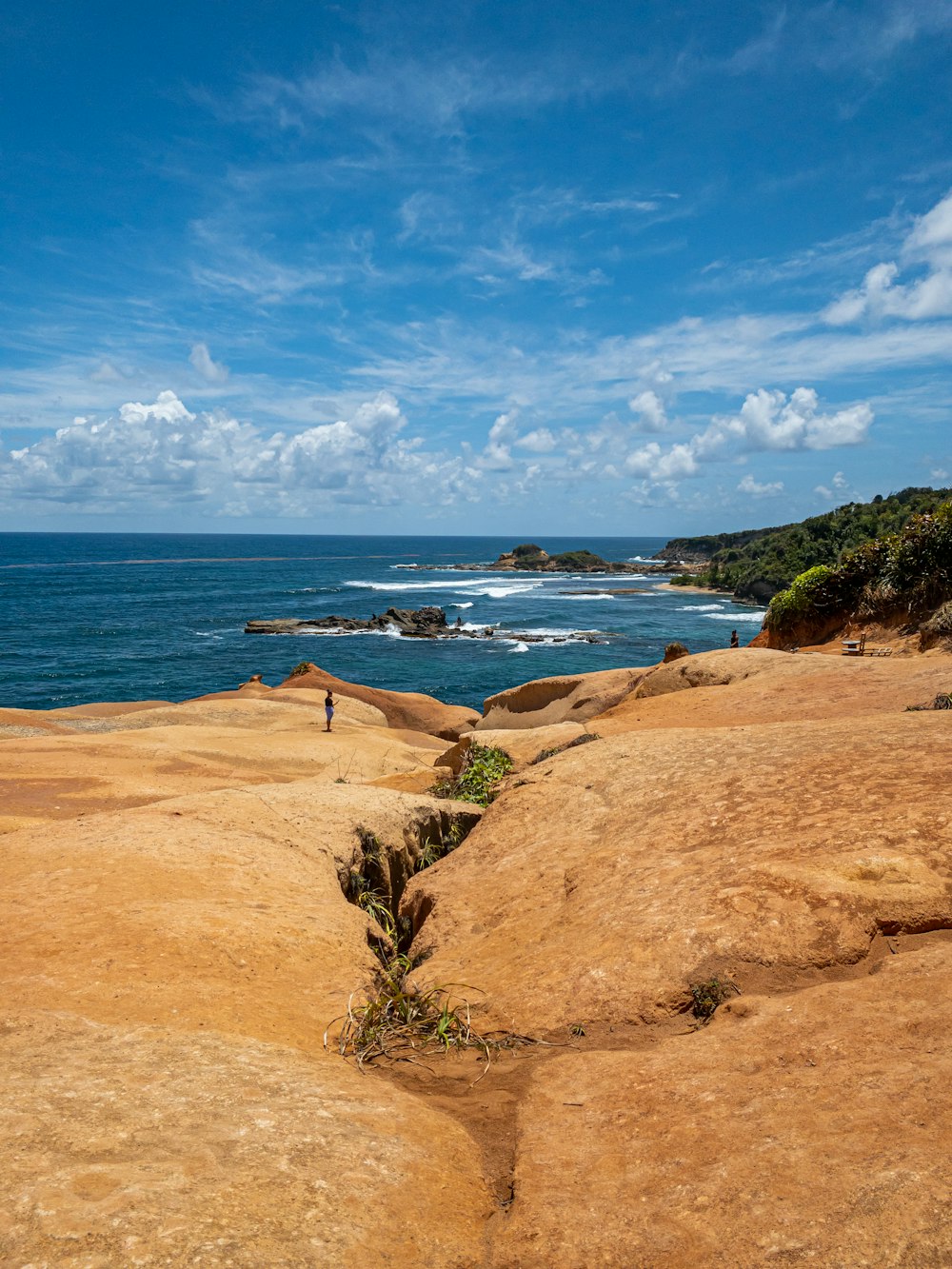 a sandy beach with a body of water in the background