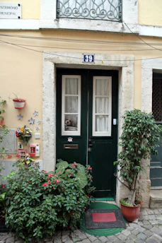 Friendly concierge greeting guests at a charming Troyes Airbnb doorway