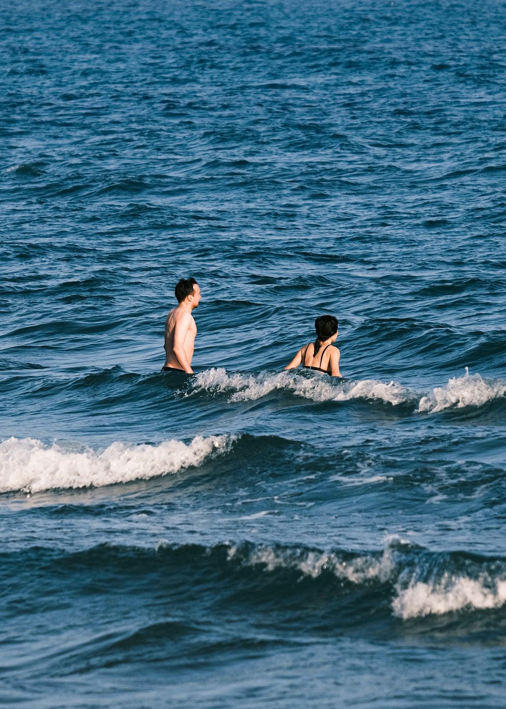 a man and woman in the ocean