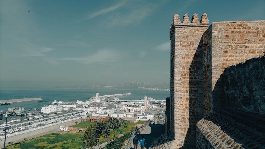 a large stone tower overlooking a city,