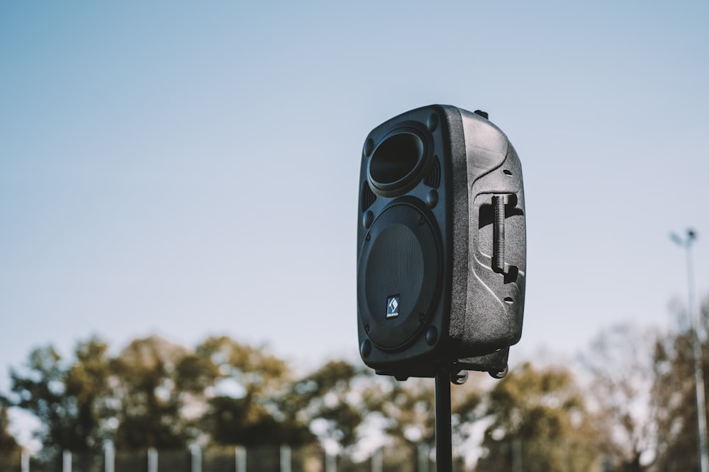 a black and white camera on a pole