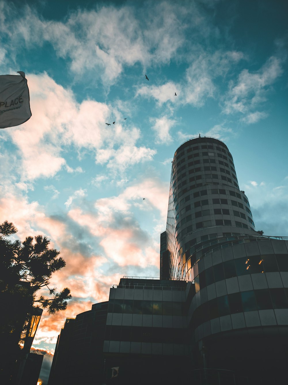 a group of buildings with a blue sky and clouds