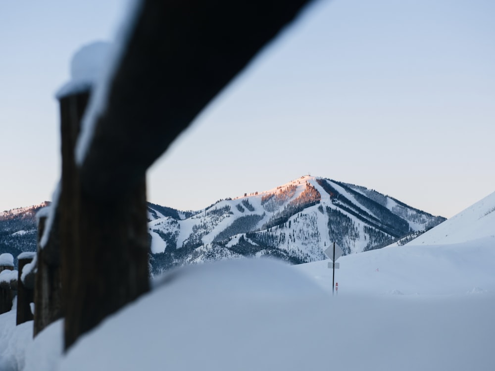 a man flying through the air on a snow covered mountain