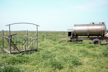 a large metal tank in a field