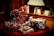 A collection of gift boxes wrapped in various plaid and striped patterns is stacked on a table. A warm lamp illuminates the scene, creating a cozy and inviting atmosphere. Greeting cards are placed in the background near a window, adding to the festive setting.