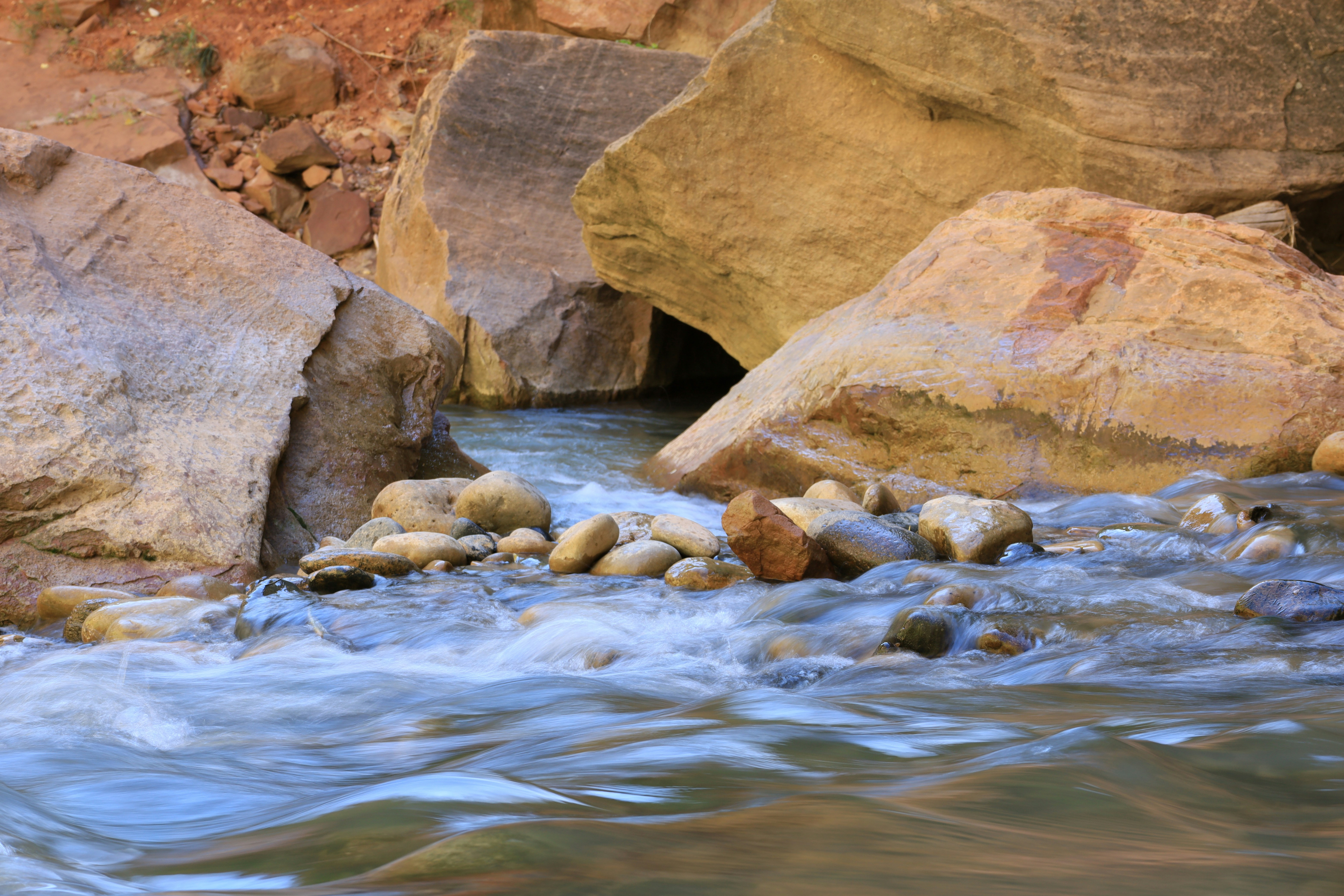 a river with rocks and a waterfall