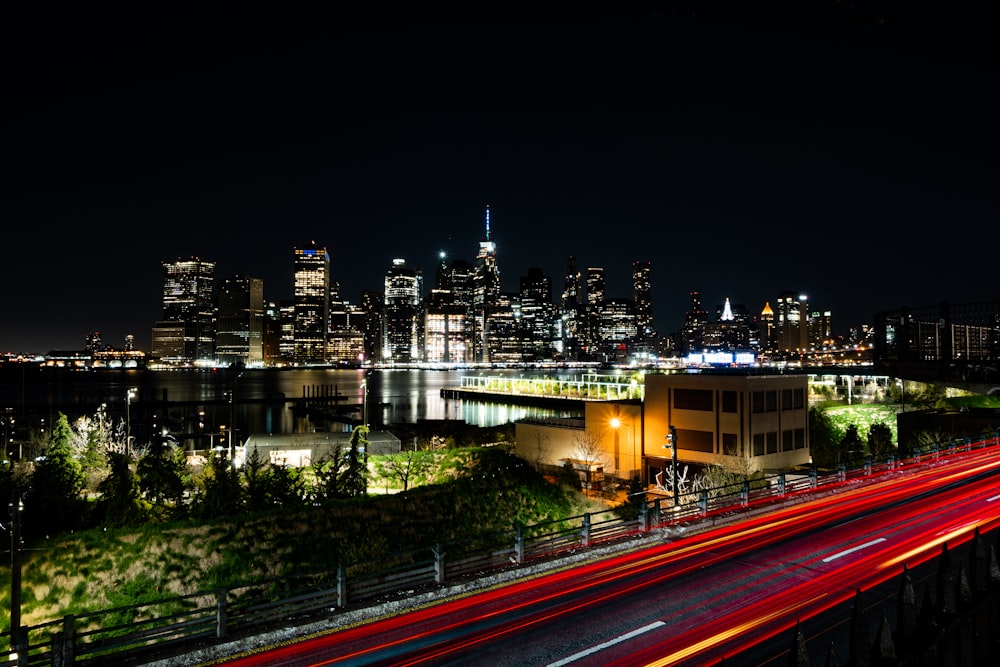 a city with a bridge and a river at night