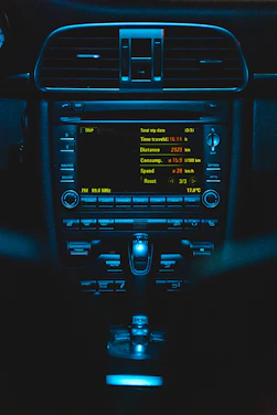 A sleek navy blue and silver dashboard screen displaying live vehicle tracking data with high-visibility accents.