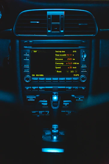 A sleek navy blue and silver dashboard screen displaying live vehicle tracking data with high-visibility accents.