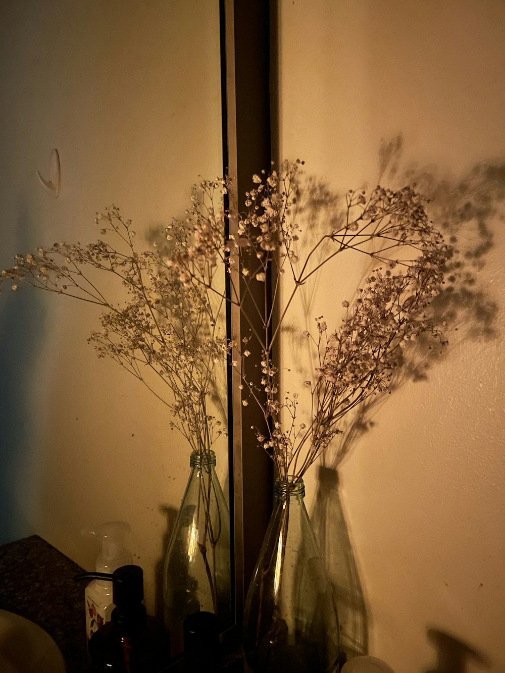 a couple of vases hold flowers