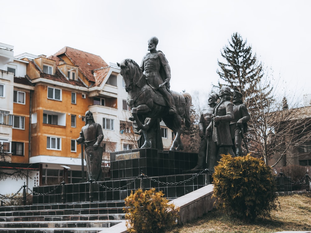 a group of statues outside of a building