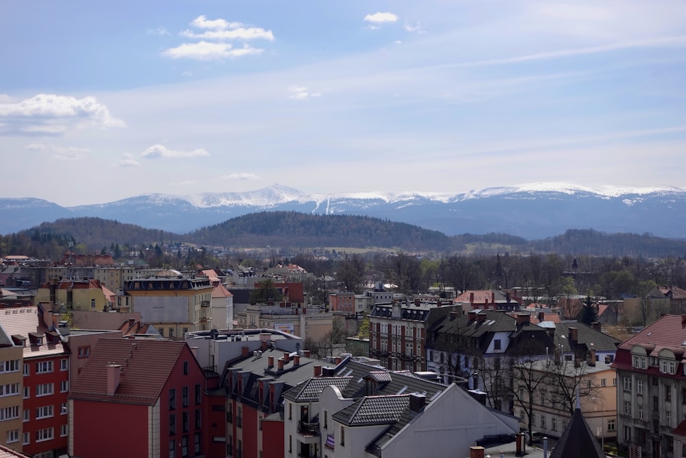 a city with many buildings and mountains in the background