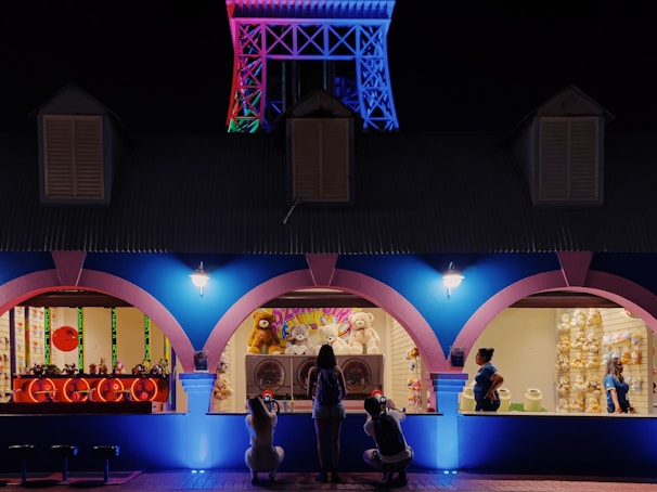 Colorful VR carnival game interface displayed on a screen with players eagerly watching.