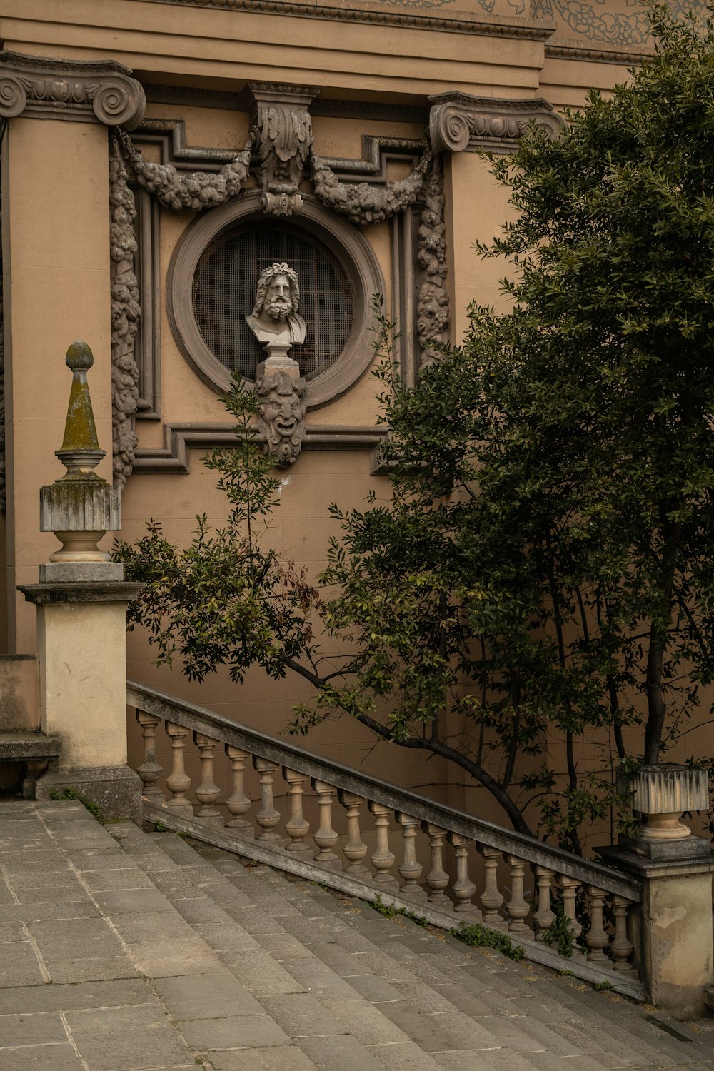 a stone building with a statue on the top