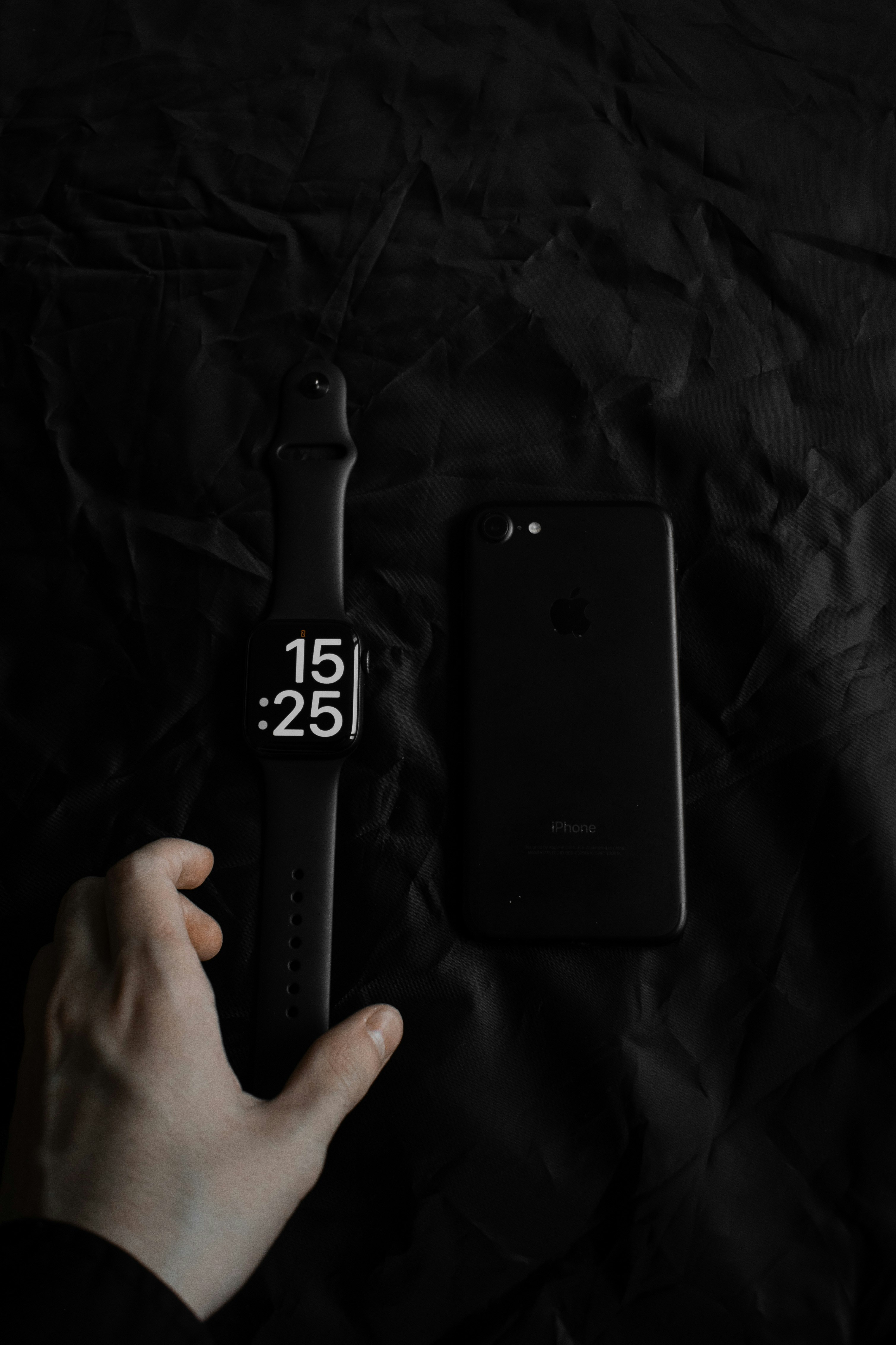 a hand holding a black device