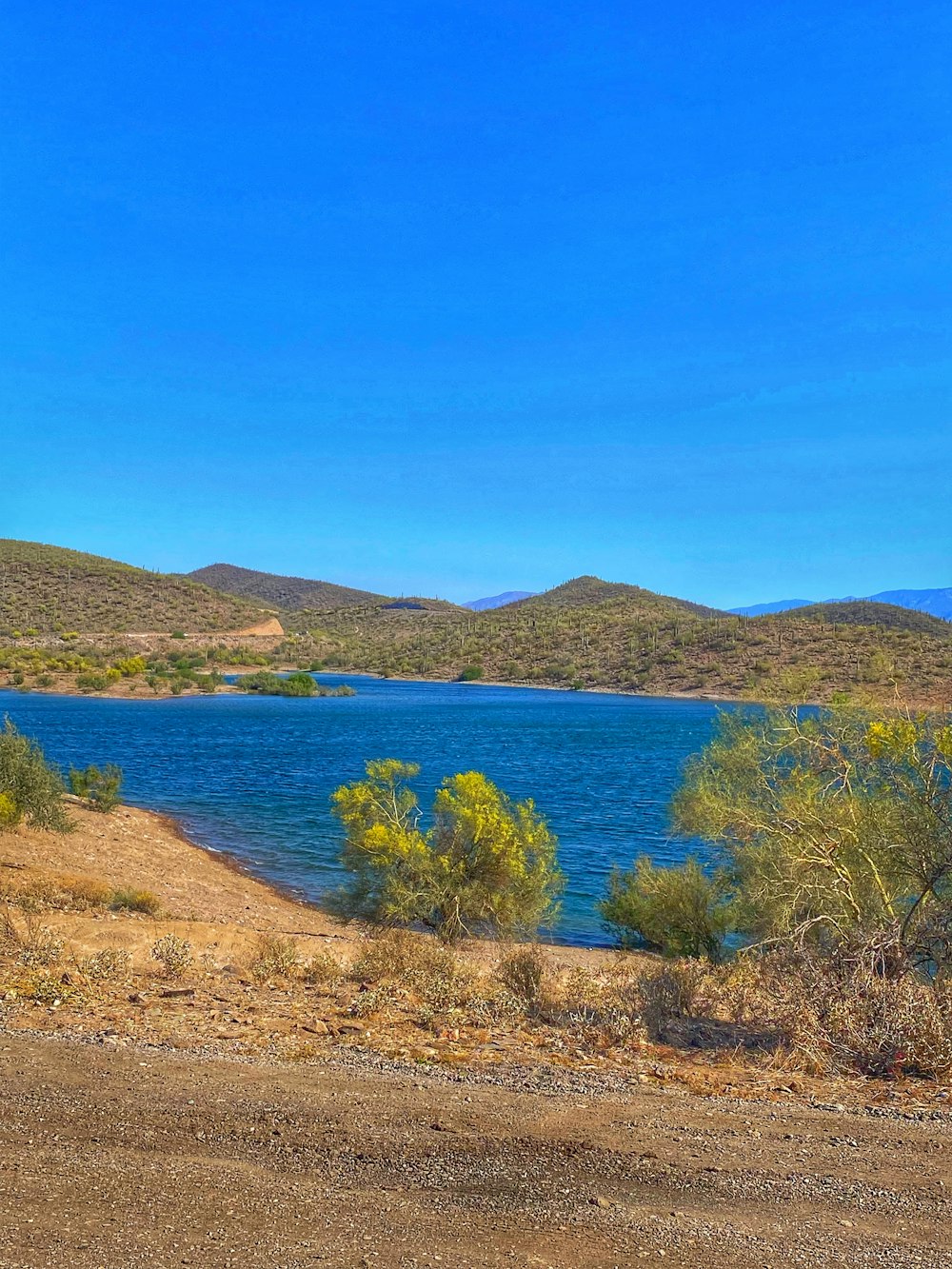 a body of water with hills in the background