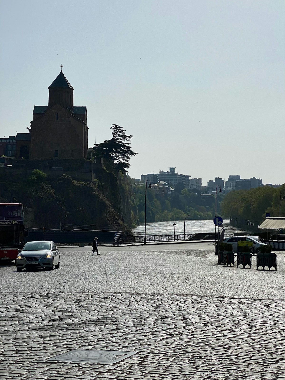 Tbilisi April — Metekhi Church and the Old Town panorama seen from across the Mtkvari in spring