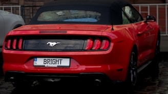 Yellow convertible with rental price tag shown on the dashboard