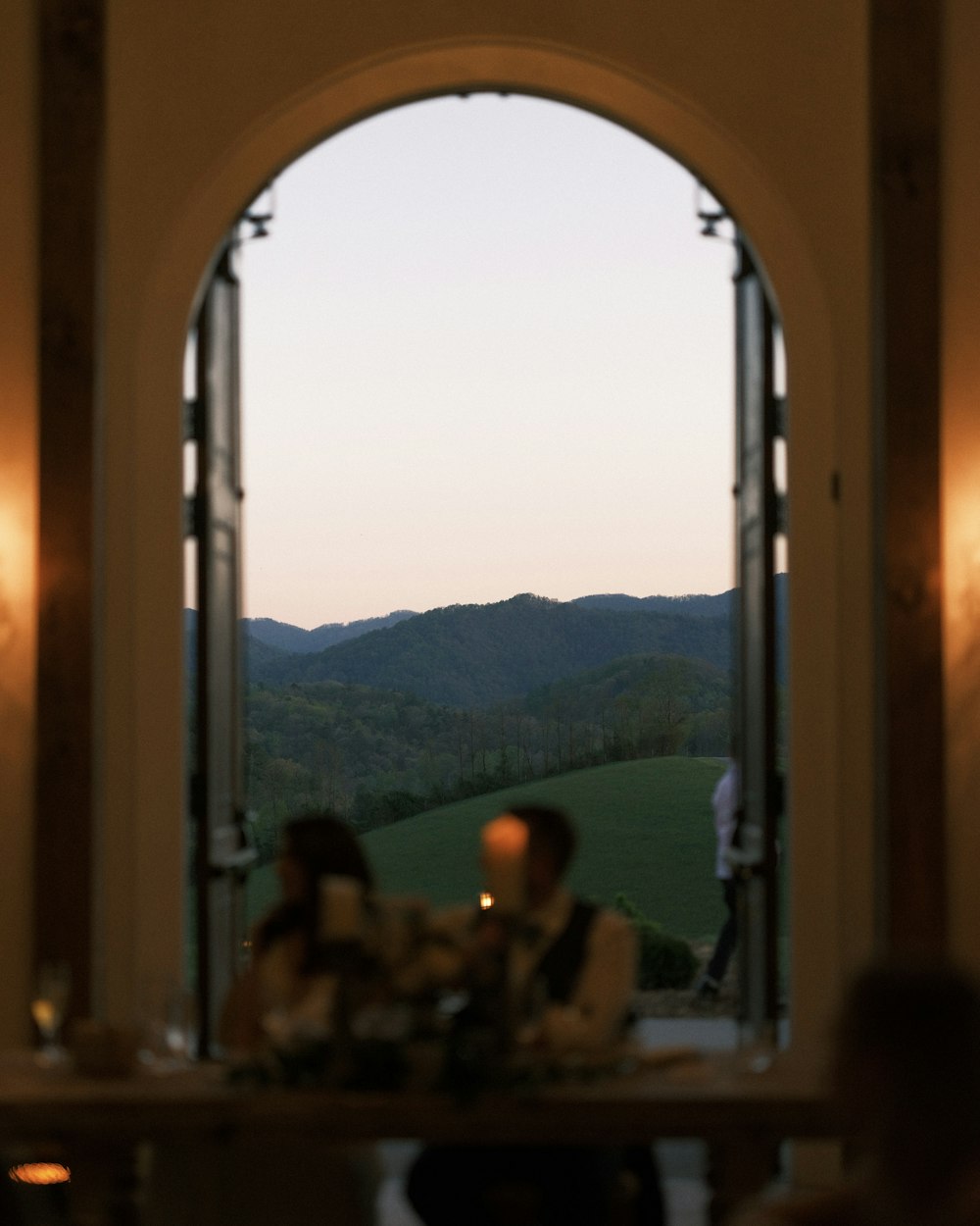 a group of people sitting at a table looking out a window