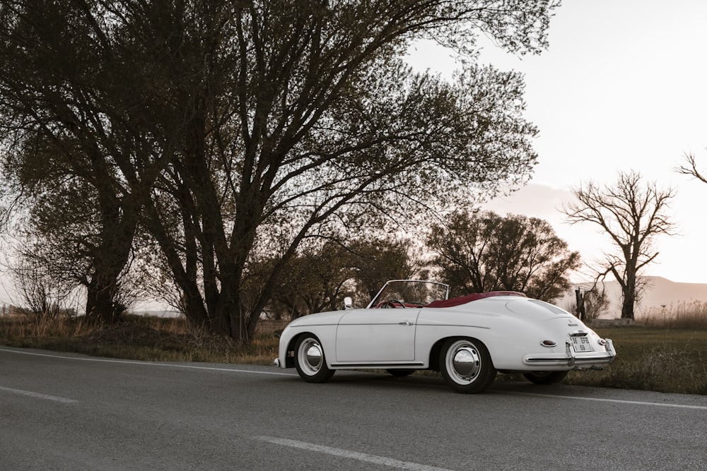 a white convertible car on a road