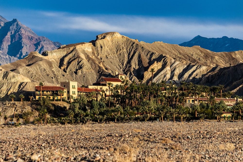 a group of buildings in front of a mountain