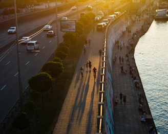 Sunset view of an outdoor recreational area with people cycling and walking.