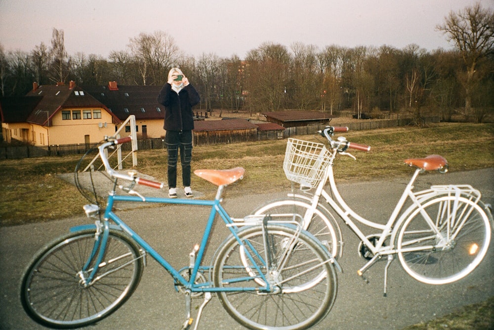 a person standing next to bicycles