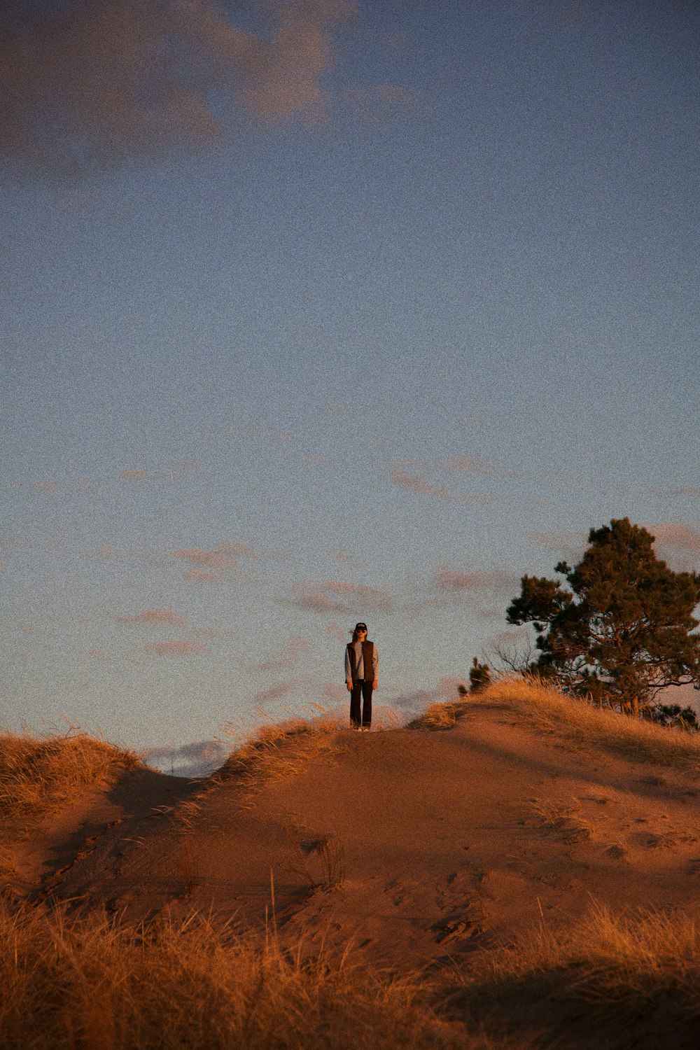 a person standing on a dirt road