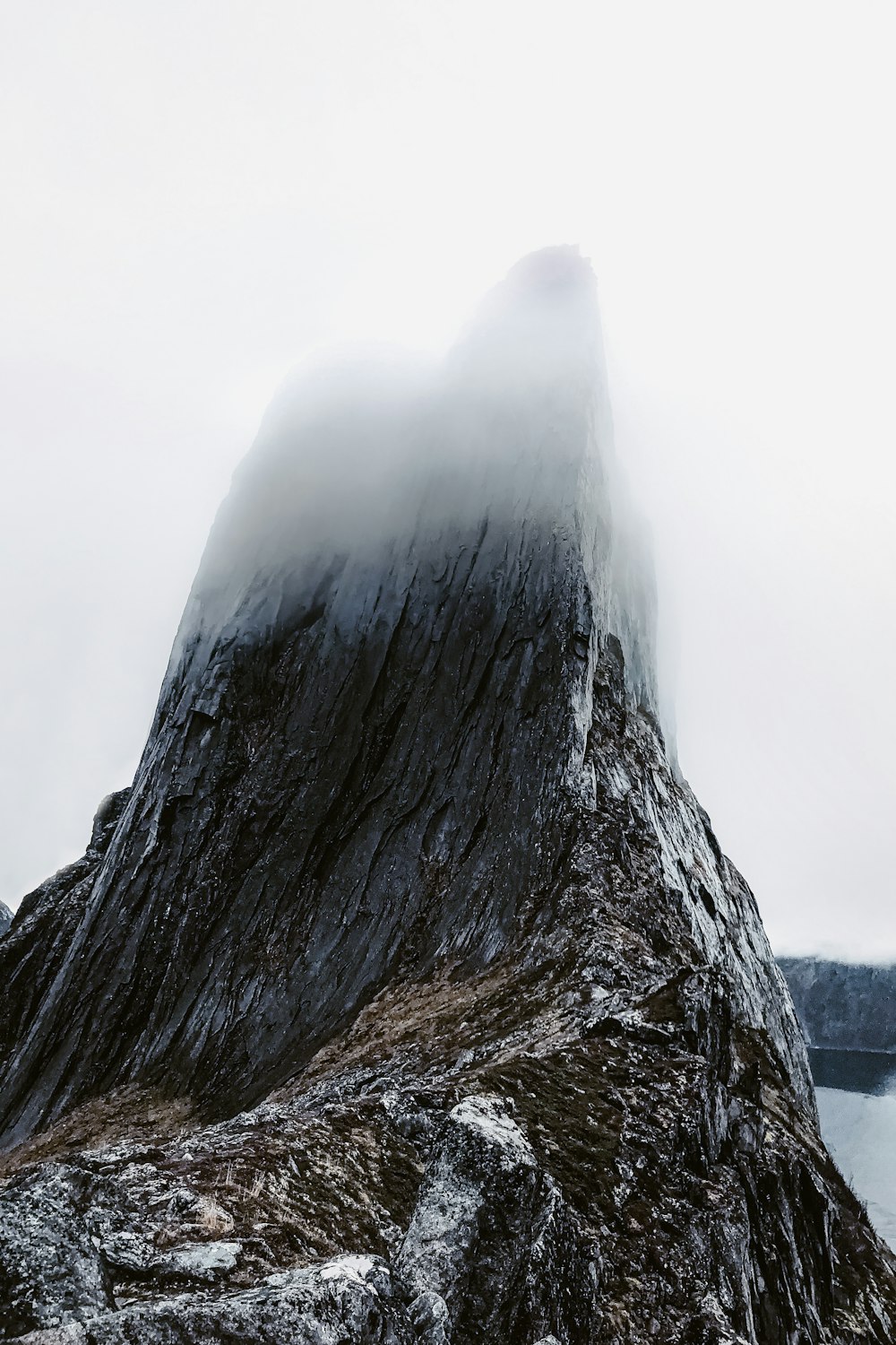 a large rock with a waterfall