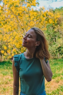 Woman smiling peacefully in a sunny garden, feeling relief from menopause symptoms.
