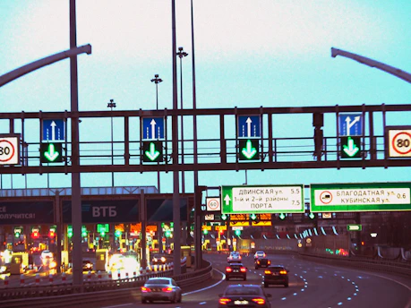 A highway toll booth with multiple lanes and signage indicating vehicle classes.