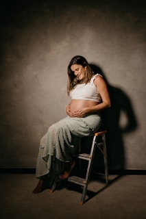 a woman sitting on a stool