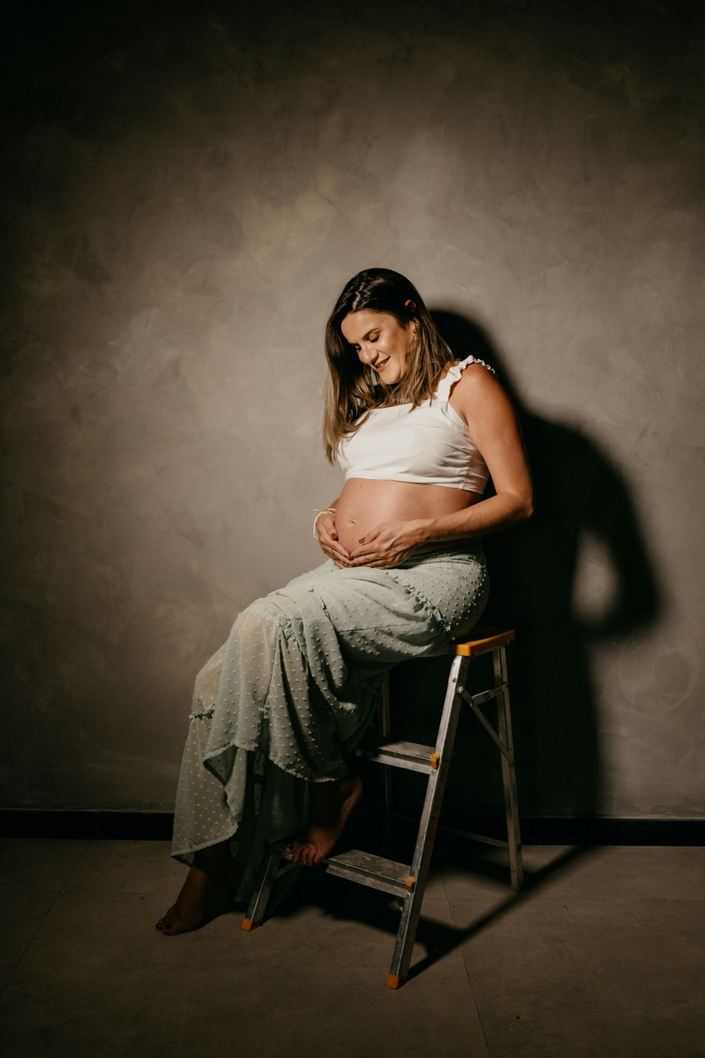 a woman sitting on a stool