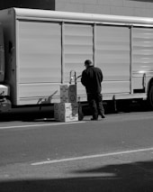 a man standing next to a truck