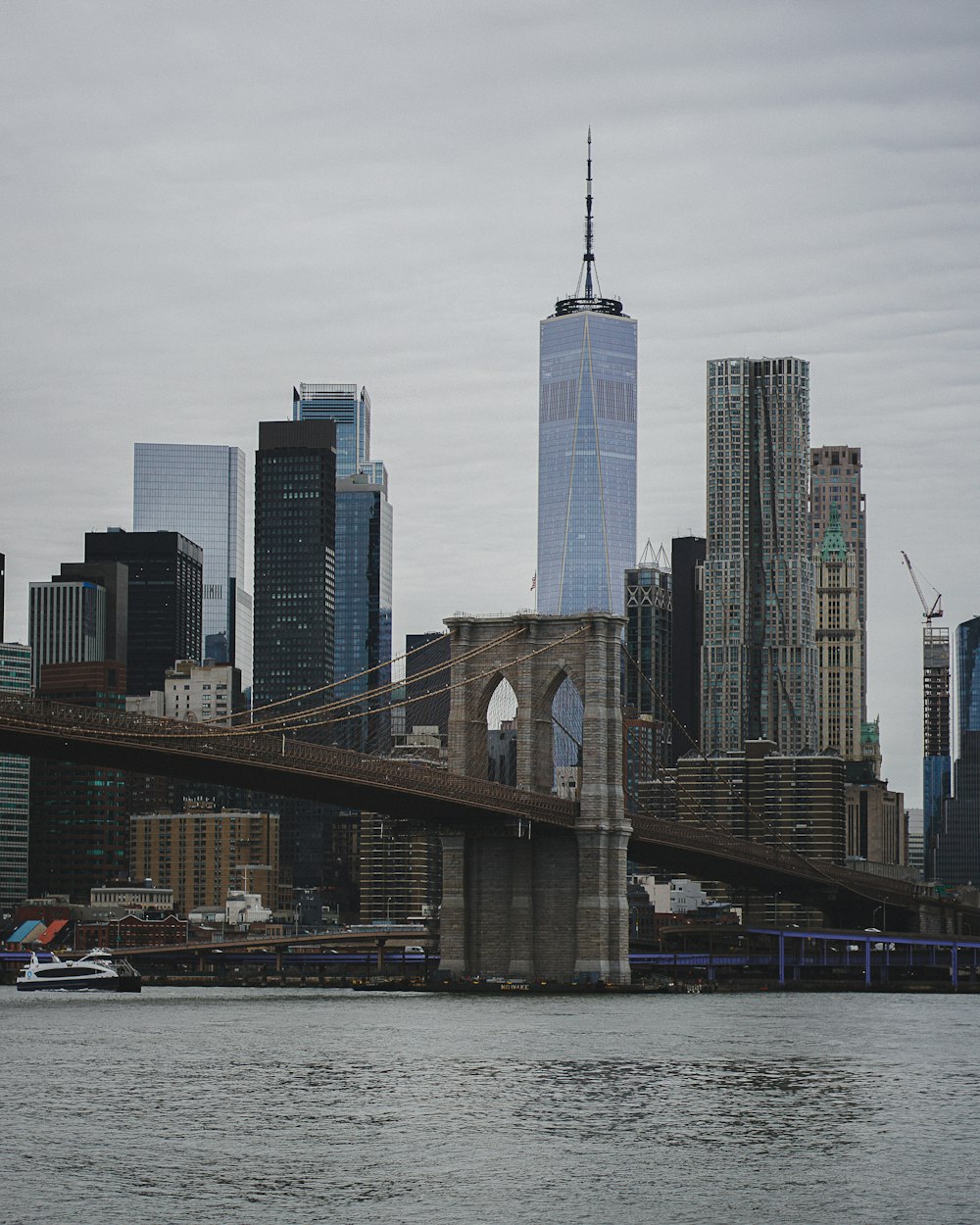 a bridge over water with a city in the background