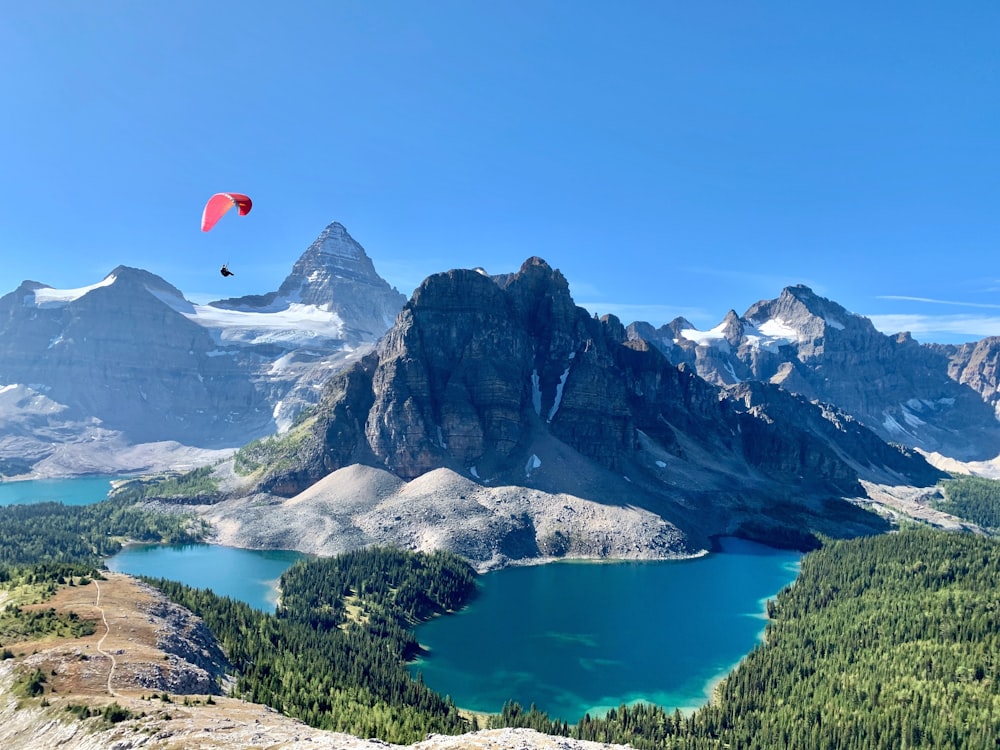 a person parachuting over a lake