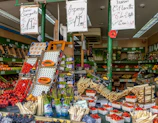 Close-up of a vibrant farmer’s market stall showcasing fresh produce with matte forest green crates and parchment tags.