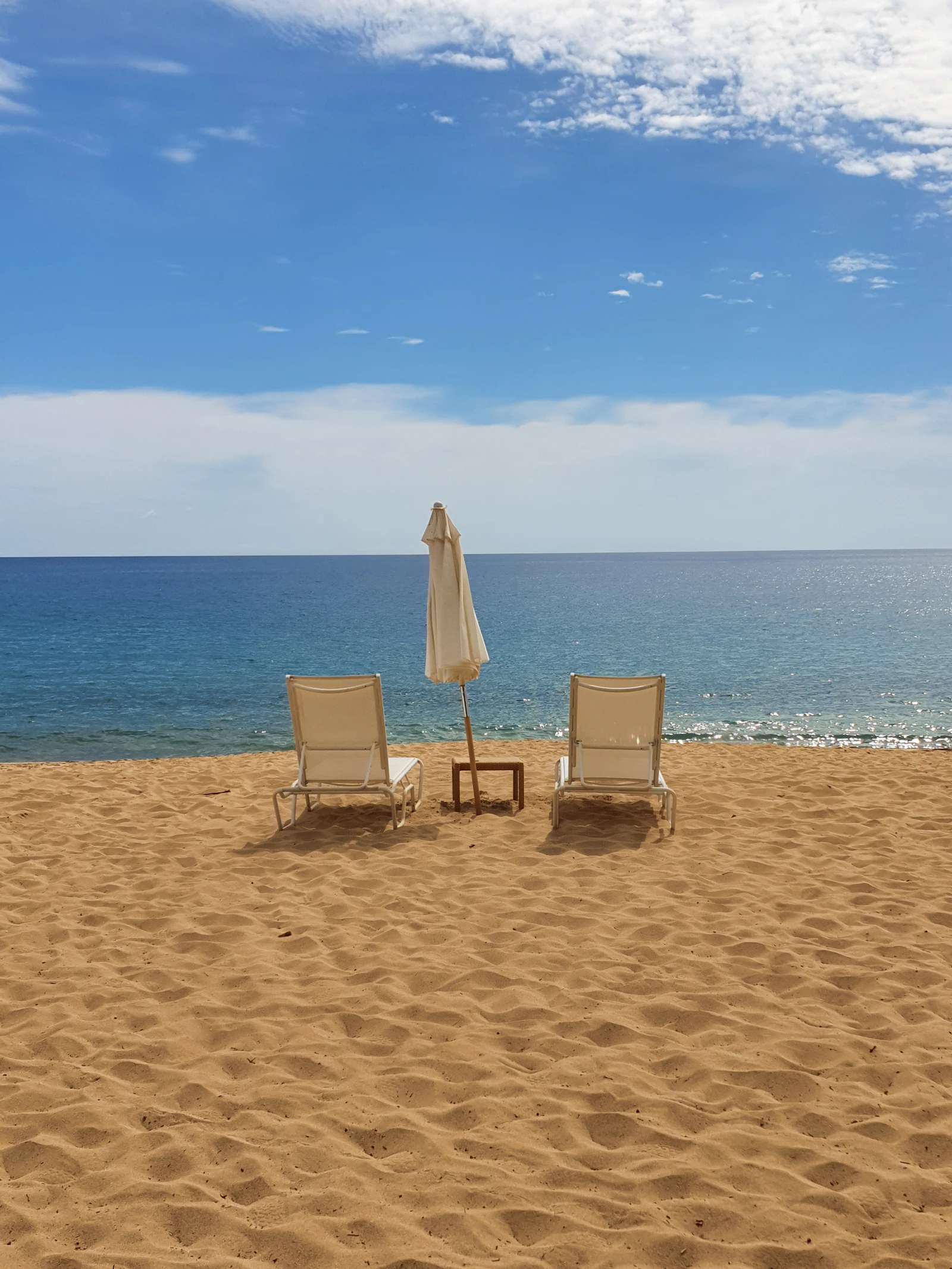 Beach chairs overlooking the ocean at Hulopoe Beach on Lanai Hawaii