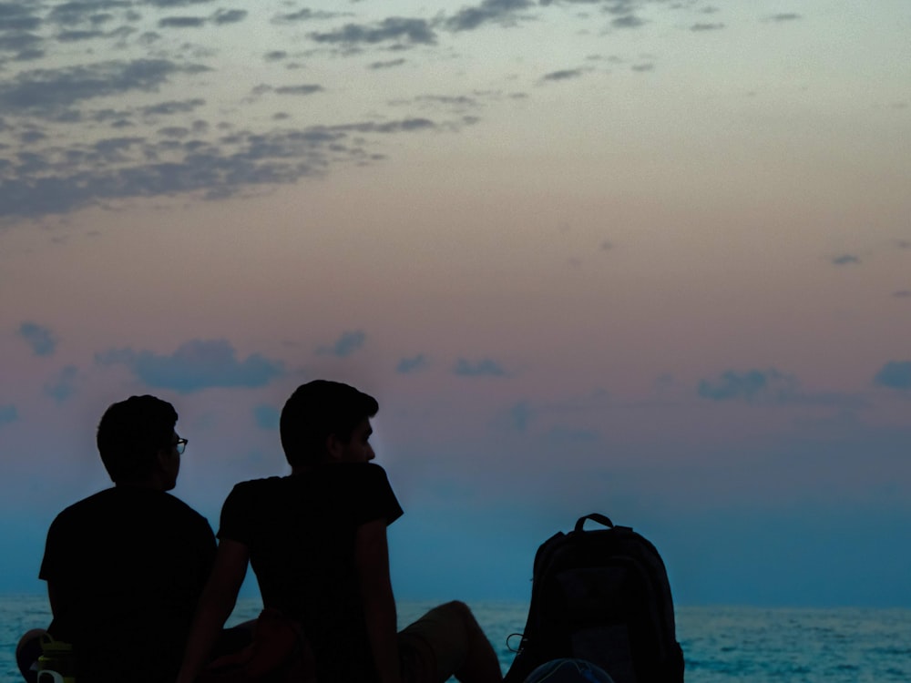 a couple of people sitting on a boat looking at the water