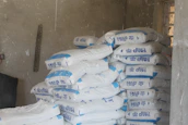 Warehouse stacked with neatly arranged bags of high-quality coke.