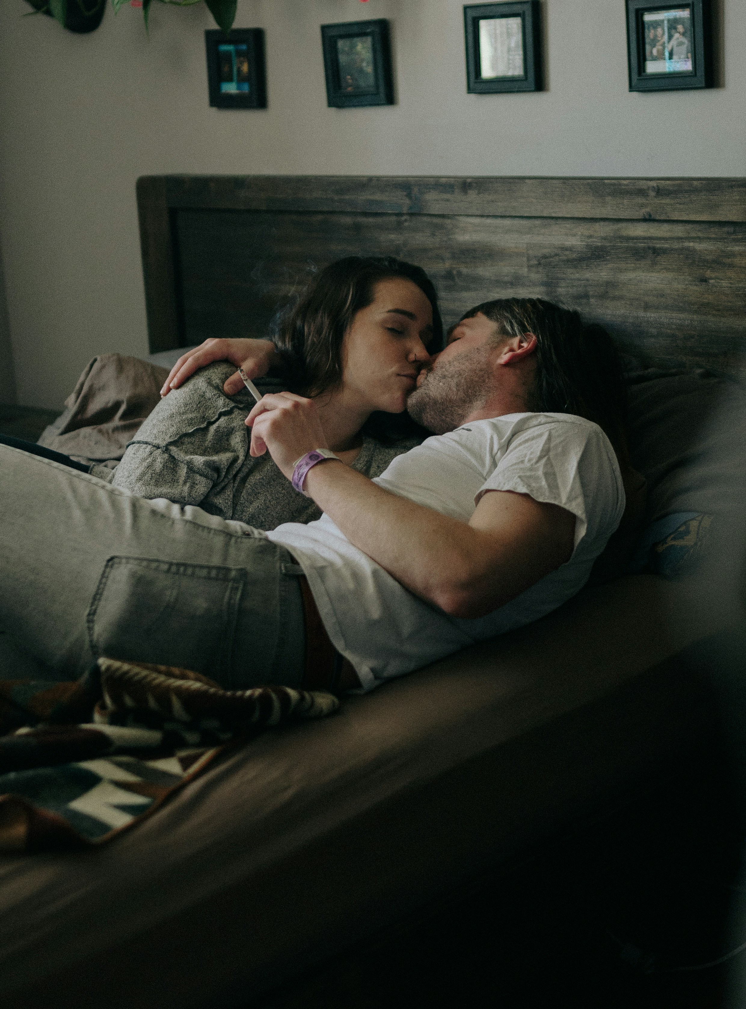 a man and woman kissing on a bed