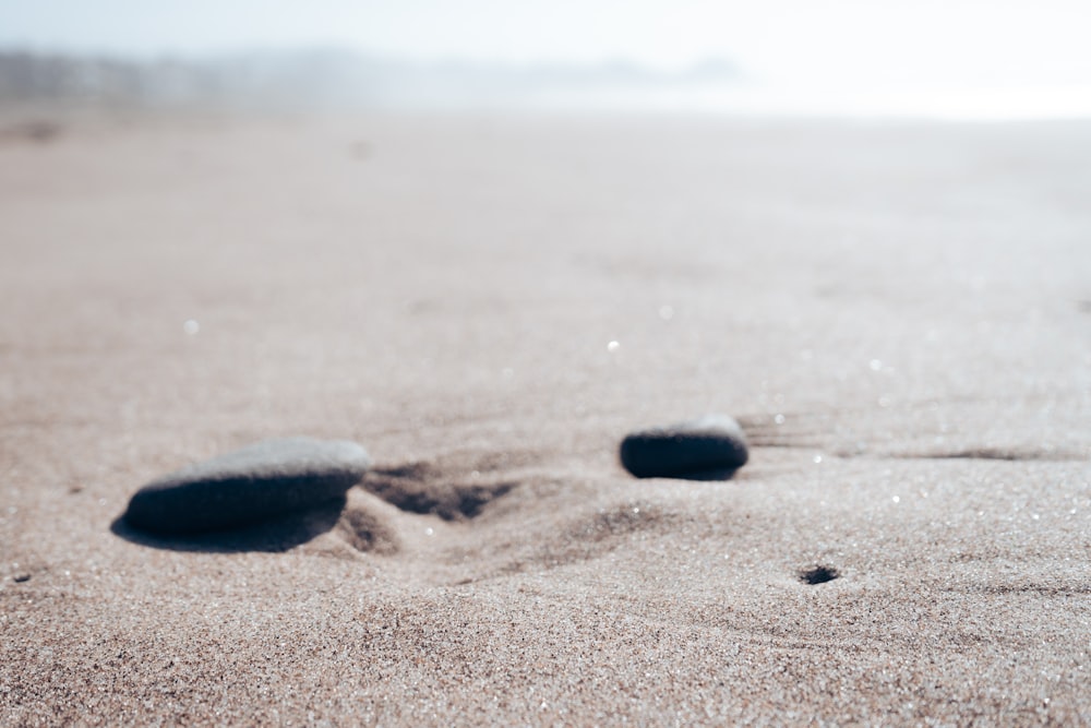a black rock on a beach