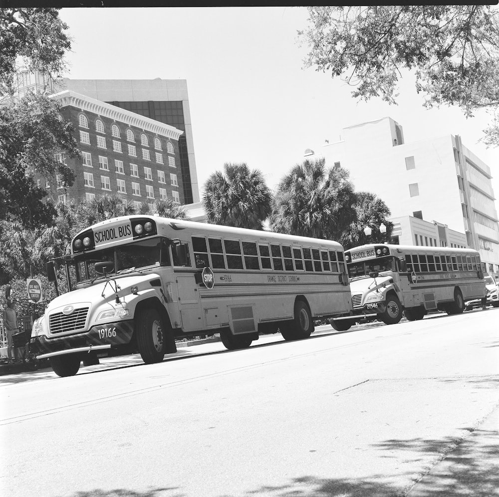 a group of buses parked on the side of a street