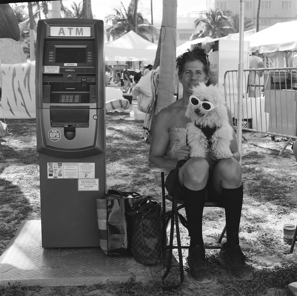 a woman sitting on a stool holding a teddy bear