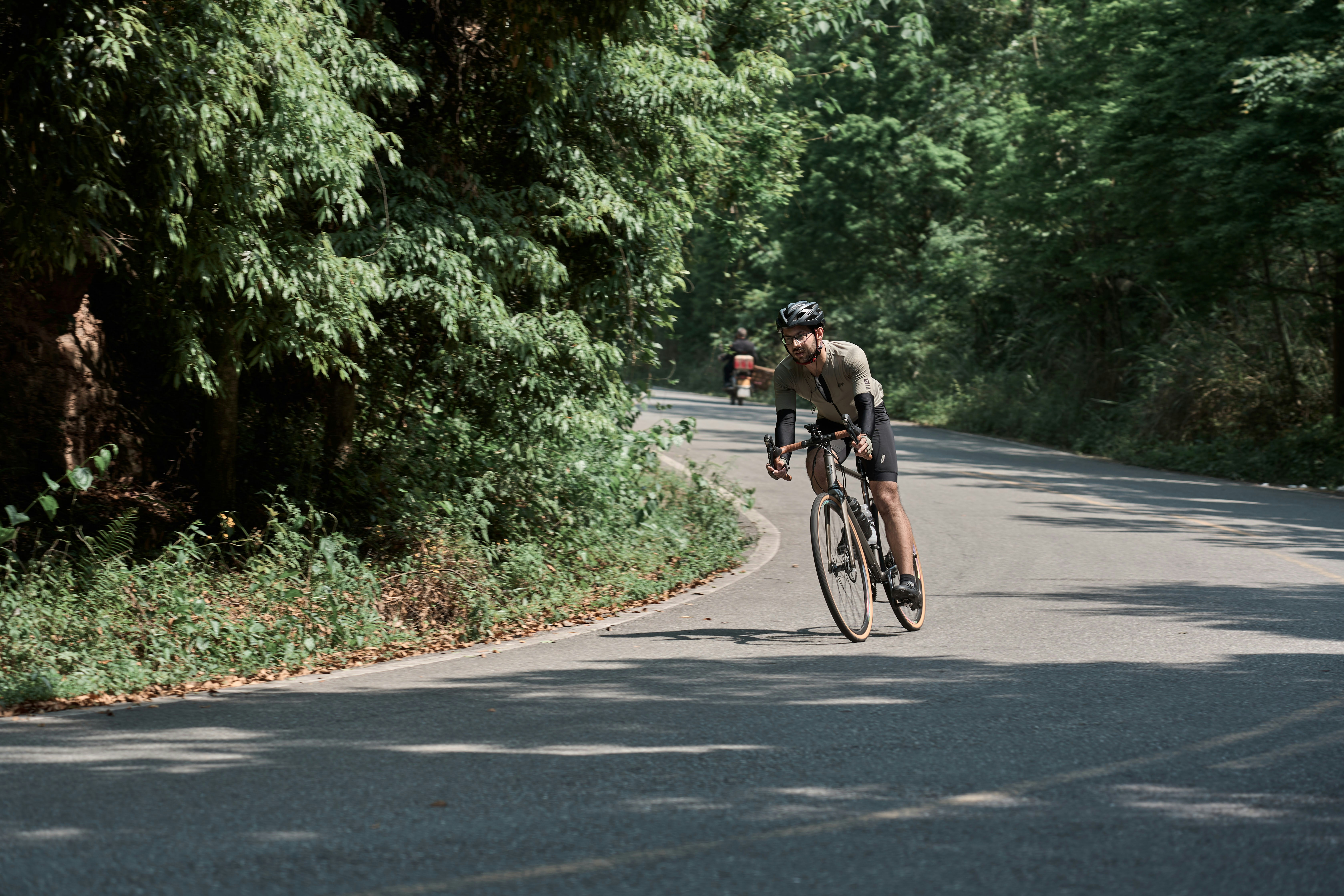 a person riding a bicycle on a road