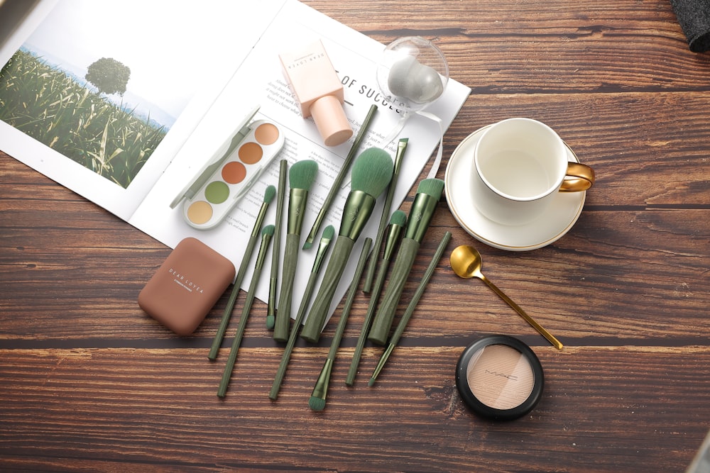 a group of pens and a cup of coffee on a table