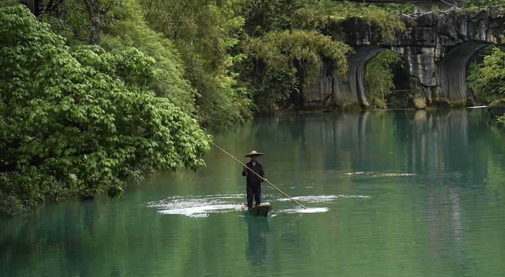 a person paddle boarding in a river