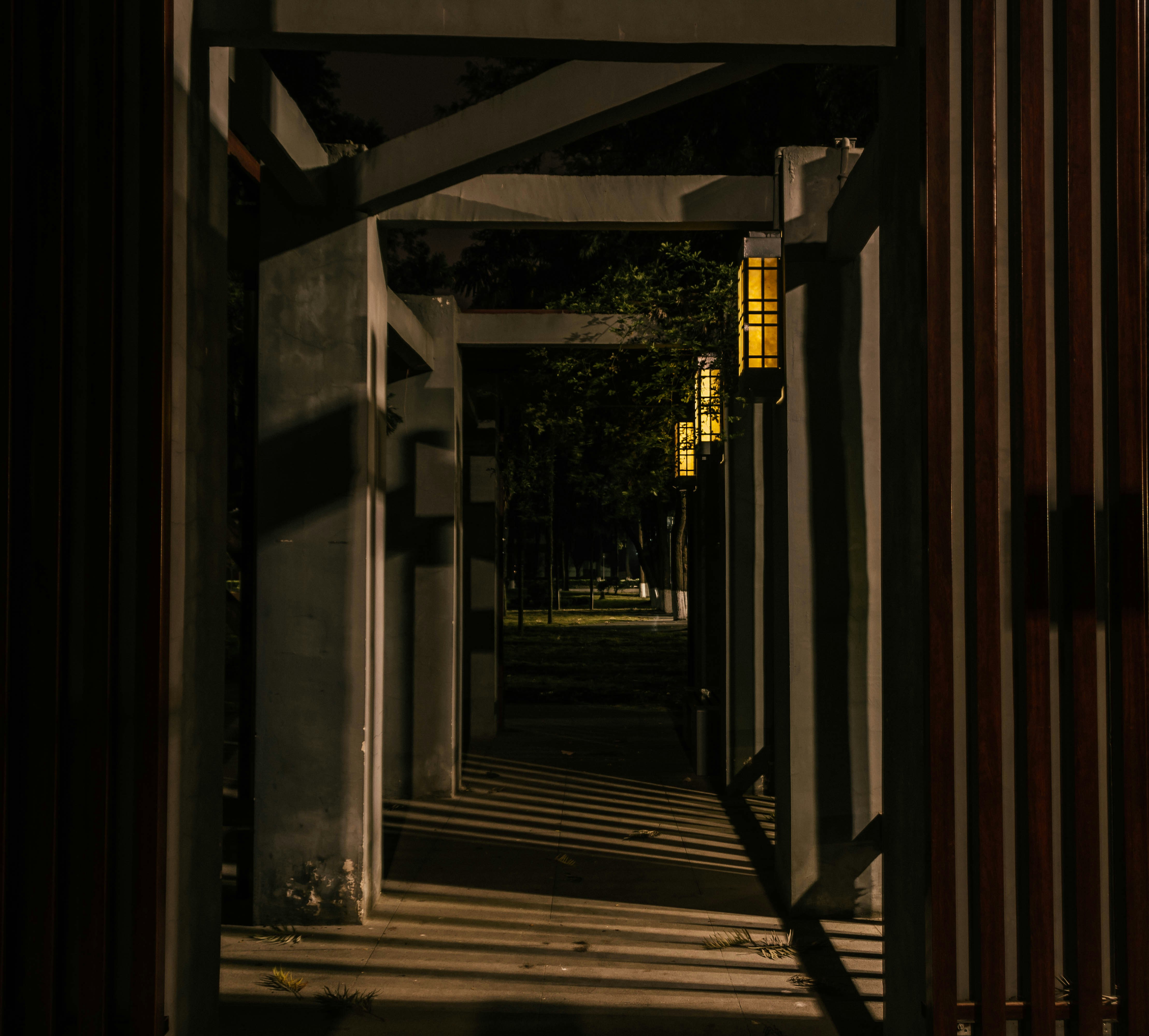 a dark hallway with a light on the end