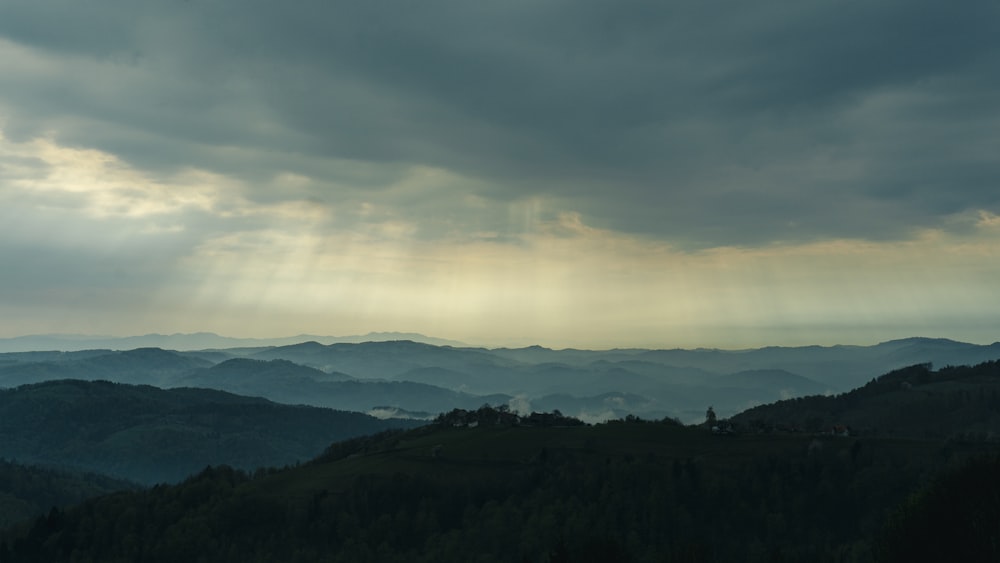 a landscape with hills and clouds